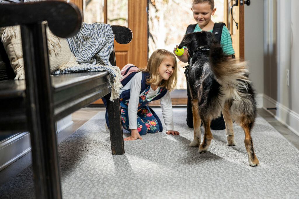 Kids on carpet floor with pet friendly | Larry Lint Flooring